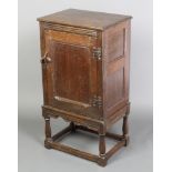 A 17th/18th Century style oak pot/side cabinet fitted a panelled with door with iron H framed
