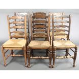 A harlequin set of 6 elm ladder back dining chairs with woven rush seats, raised on club supports