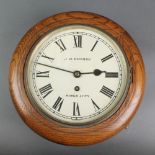 A wall clock with 8 1/2" dial with Roman numerals marked J H Empson Kings Lynn contained in an oak