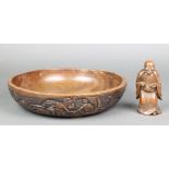 A circular carved African hardwood bowl decorated figures 12" and a Chinese carved hardwood figure