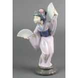 A Lladro figure of a Japanese lady holding fans 4991 11 1/2" Some of the flowers are chipped