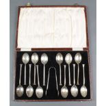 A set of 12 cased silver teaspoons and nips with seal ends Birmingham 1926, 112 grams