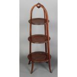 An Edwardian circular mahogany 3 tier cake stand of tapering form 35"h x 12" diam at widest The 2