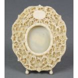 A carved and pierced ivory easel photograph frame decorated with flowers 4 1/2" x 4"