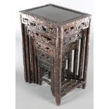 A nest of 5 Chinese carved and pierced hardwood interfitting coffee tables - largest 27"h x 18"w x