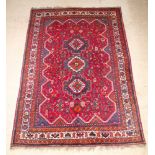 A brown, green and white ground Persian Qashqai carpet 122" x 87"