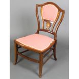 An Edwardian inlaid mahogany shield shaped bedroom chair, raised on square tapered supports