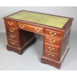 A 19th Century mahogany kneehole pedestal desk with green inset writing surface above 1 long and 8