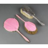 A silver and pink guilloche enamel hand mirror and hair brush Birmingham 1936/37 and a silver backed
