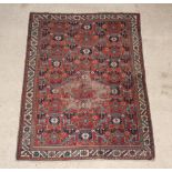 An Antique Persian Malayer brown ground rug 78" x 57", in wear