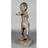 A Benin bronze figure of a standing man with rifle on a square base 18"