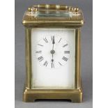 A French 8 day carriage clock with enamelled dial and Roman numerals, contained in a gilt metal case