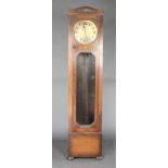 A 1930's chiming longcase clock, striking on a gong, the 12" brassed dial with Arabic numerals