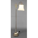 A standard lamp with reeded column raised on an embossed brass and onyx base