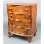A Victorian style mahogany apprentice chest of 4 long drawers with tore handles, raised on bracket