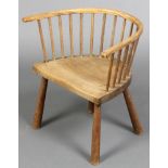 A child's elm stick and tub back chair, raised on turned supports 17"h x 16 1/2"w x 10"d