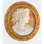 A Victorian etruscan style gilt cameo portrait brooch with a well carved portrait of a lady