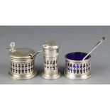 A silver 3 piece condiment with pierced decoration and blue glass liners with 1 silver and 1