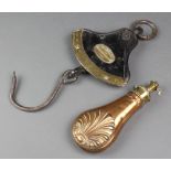 A copper and brass powder flask with shell decoration, the spout marked Dams 8" (split to the