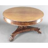 A Victorian circular oval extending table, raised on a turned column and triform base with scroll