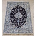 A blue and white ground Nain rug with central medallion 80" x 59"