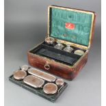 A Victorian leather bound toilet/jewellery box with silver plated mounted jars and compartments 1
