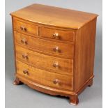 A Victorian style apprentice bow front chest of 3 drawers with tore handles, raised on bracket