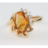 A 14ct yellow gold citrine and diamond cocktail ring, size L