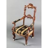 A childs Victorian carved mahogany open arm chair, upholstered in blue and cream striped material,