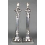 A pair of plated reeded table lamps on square bases 21"