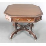 A Maples & Co octagonal mahogany aesthetic movement library table with inset writing surface