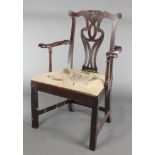 A Georgian mahogany Chippendale style carver chair with slat back and upholstered seat, raised on