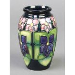 A modern Moorcroft baluster vase decorated with violets 4 1/2"