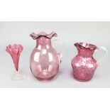 A Victorian cranberry glass jug with clear glass handle 8", a dimpled ditto 6" and a tapered vase 6"