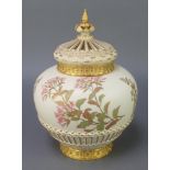 A Royal Worcester blush porcelain vase and cover with basketwork decoration and reticulated lid