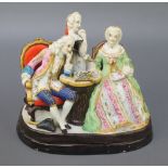 A 19th Century Continental bisque group of chess players, the base with night light holders 8" 1