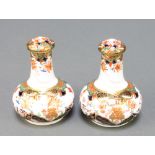 A pair of 19th Century Spode bottle vases and covers, the Imari pattern decoration with garden