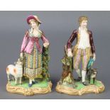 A pair of 19th Century English porcelain figures of a lady and gentleman, the lady with sheep and