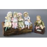 A late 19th Century KPM bowl in the form of 4 girls sitting on a tree trunk 9", a similar figure