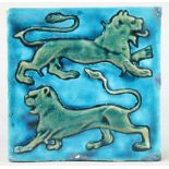 William De Morgan, a turquoise and green glazed tile decorated with 2 walking lions in relief 6" x