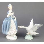 A Lladro figure of a goose 1265 5" and a Royal Doulton figure Masquerade HN2251 8"