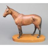A Beswick figure of a horse - Mill Reef 7" on a wooden socle together with The Story of Mill Reef by