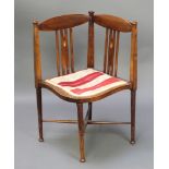 A Liberty's style Edwardian inlaid mahogany stick and rail back corner chair with shaped seat and
