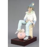 A Lladro figure of a seated boy with a puppy sitting on a ball, 13703, 61/500, with certificate,