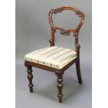 A Victorian carved rosewood balloon back dining chair with shaped mid rail and upholstered drop in