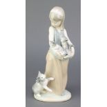 A Lladro figure of a girl holding kittens in her apron, with a cat at her feet M/270, 19", boxedThis