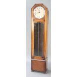 An Art Deco 8 day chiming longcase clock with 11" silvered dial contained in a shaped oak case and