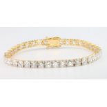 A good 18ct yellow gold 39 stone brilliant cut diamond set line bracelet, 9.9ct, 172mm
