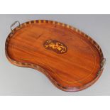An Edwardian kidney shaped inlaid mahogany twin handled tea tray, the centre inlaid musical trophies