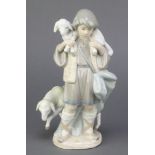 A Lladro figure of a shepherd and sheep 5485, 8" There is a firing crack to the lambs tail but